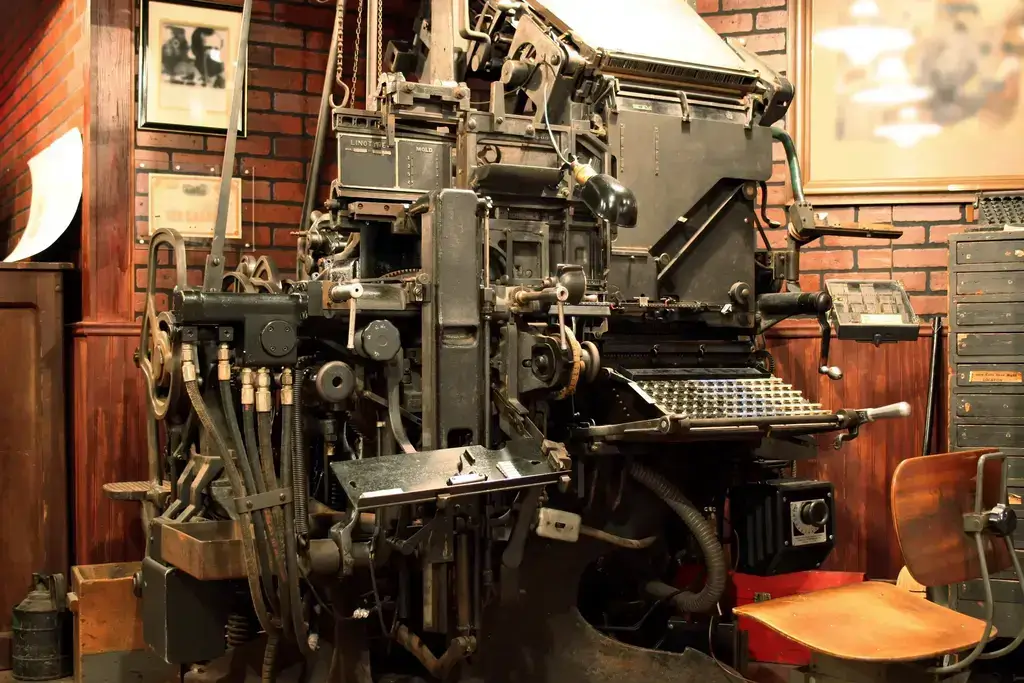 A Vintage Linotype machine (large, complicated, metal machine).