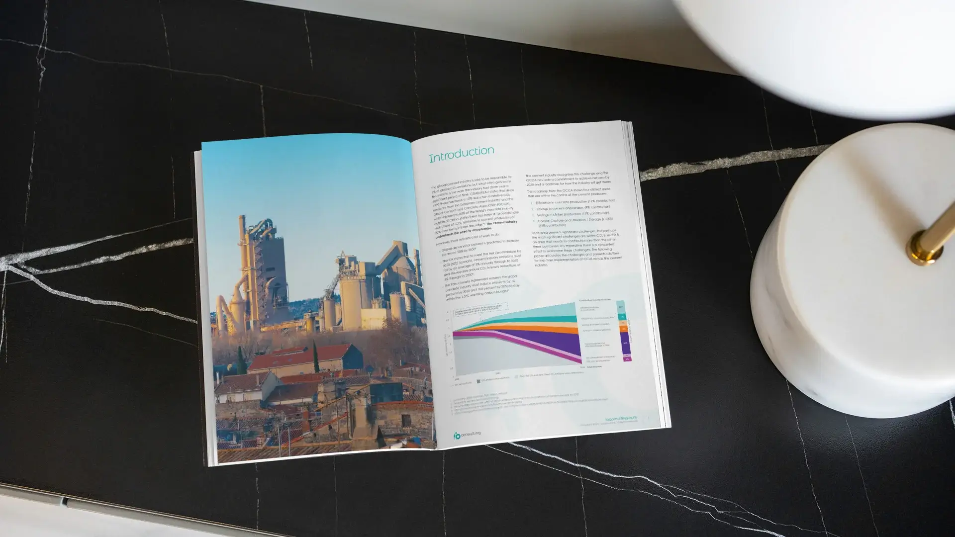 The inside spread of one of io's reports, it features a large image of an energy plant on the left and on the right a page of text and a graph.